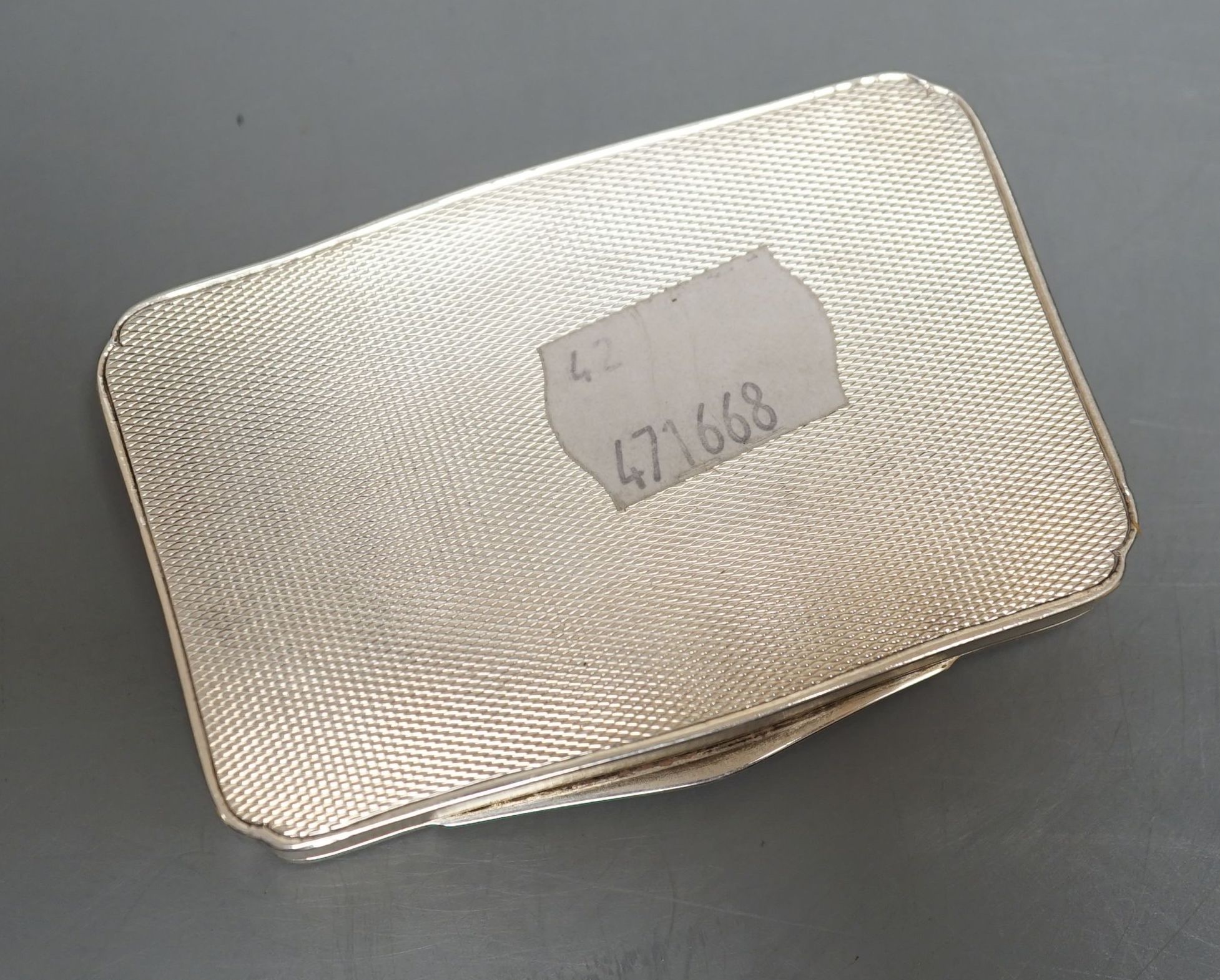 A 1920's continental silver and painted enamel rectangular snuff box, import marks for H.C. Freeman, London, 1929, 81mm, gross 103.7 grams (enamel a.f.).